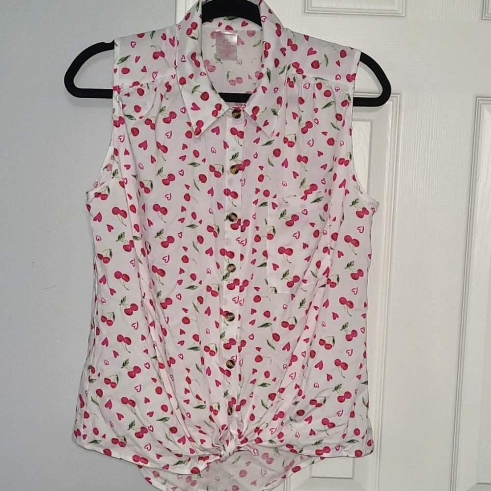 White with cherries. Button down sleeveless top.